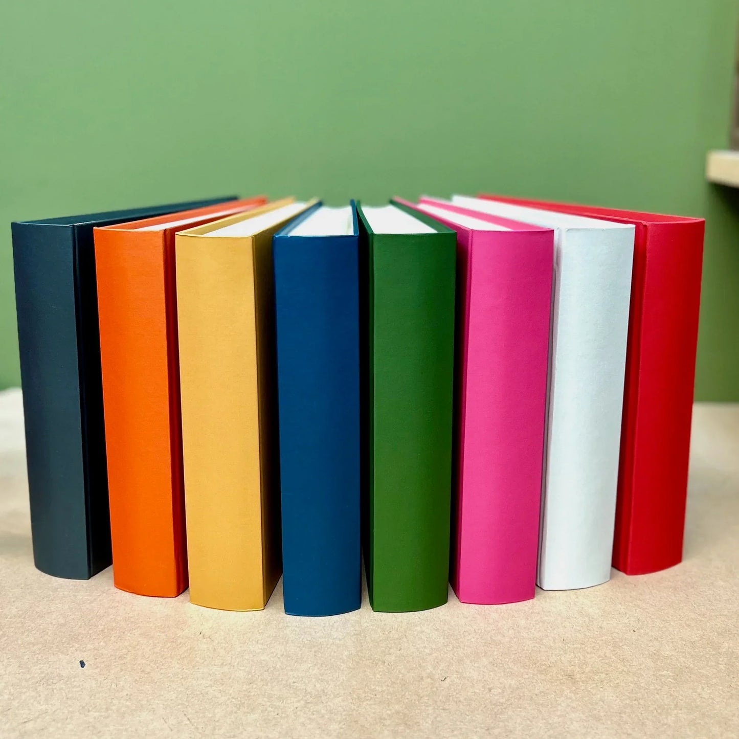 Rainbow of beautifully coloured photo albums