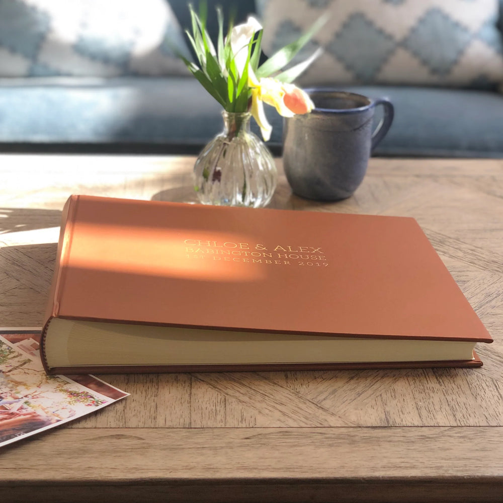 Light brown wedding guest book on coffee table