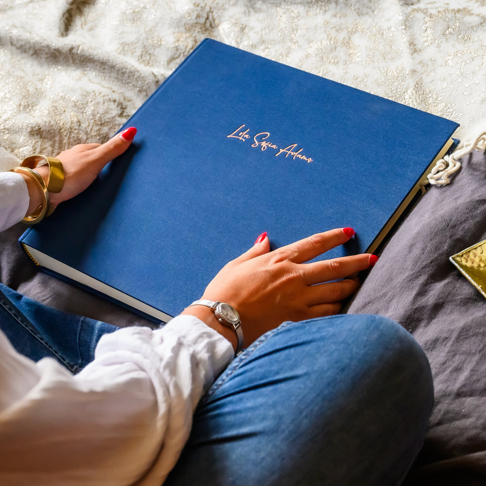 Royal blue photo album with beautifully embossed gold title