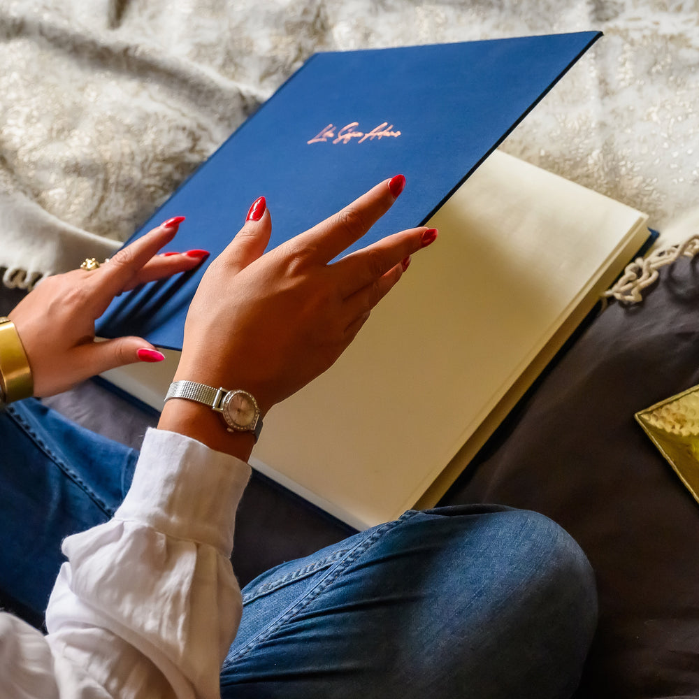 
                      
                        A woman about to start looking through a beautiful royal blue album
                      
                    