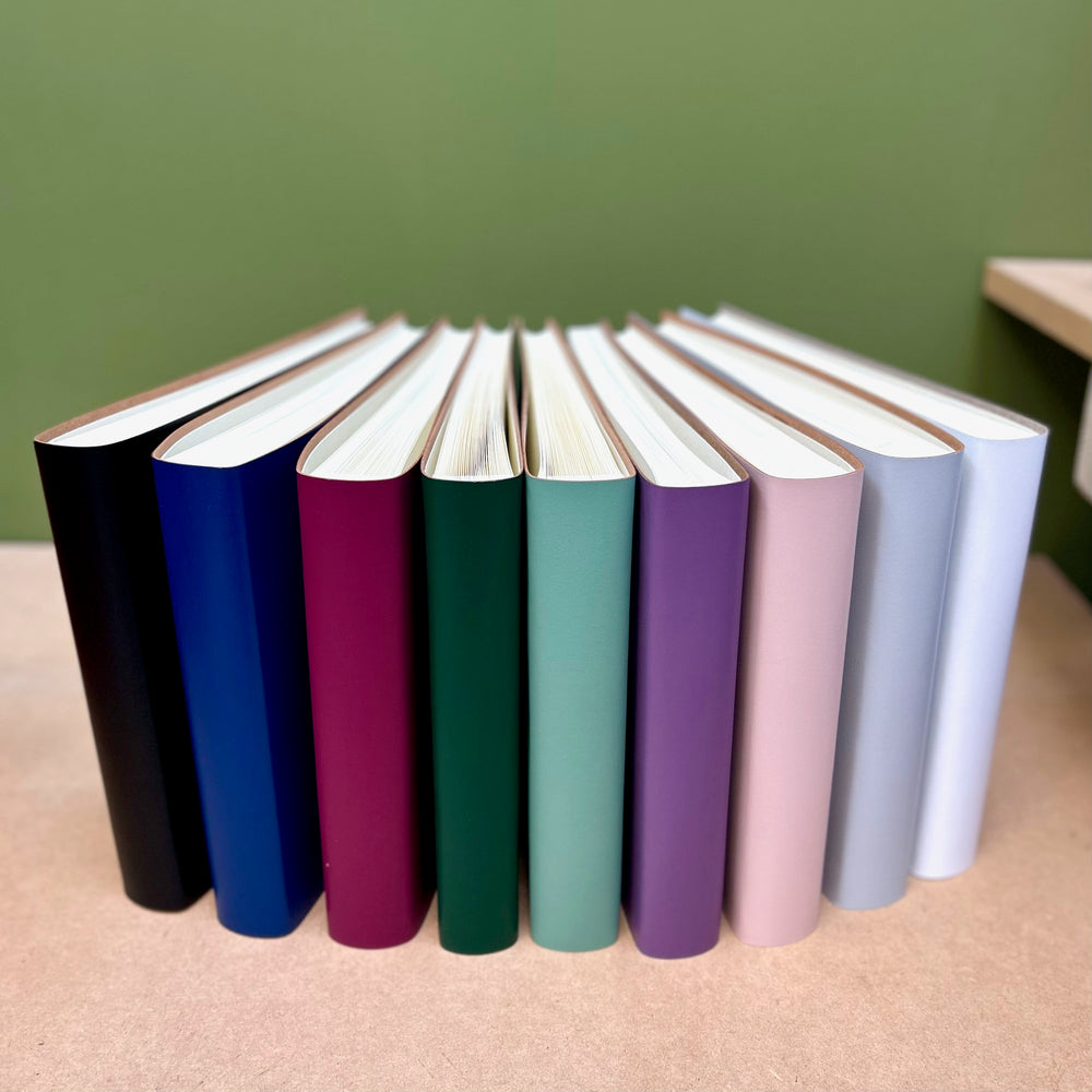 
                      
                        All the condolence books have been arranged in a fan shape so you can see all the colours, the bind and the interior.
                      
                    