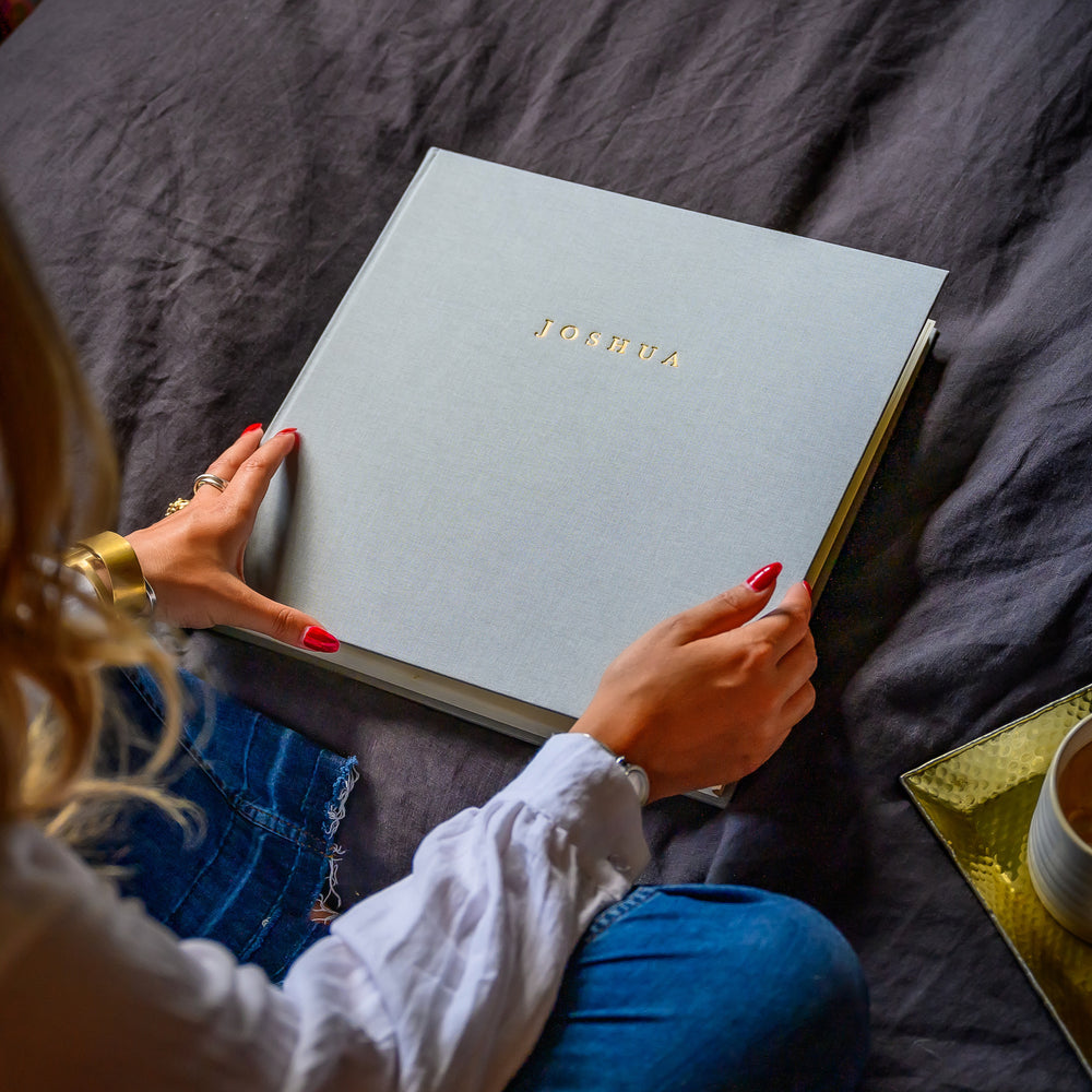 
                      
                        New baby photo album with the name Joshua embossed in gold
                      
                    