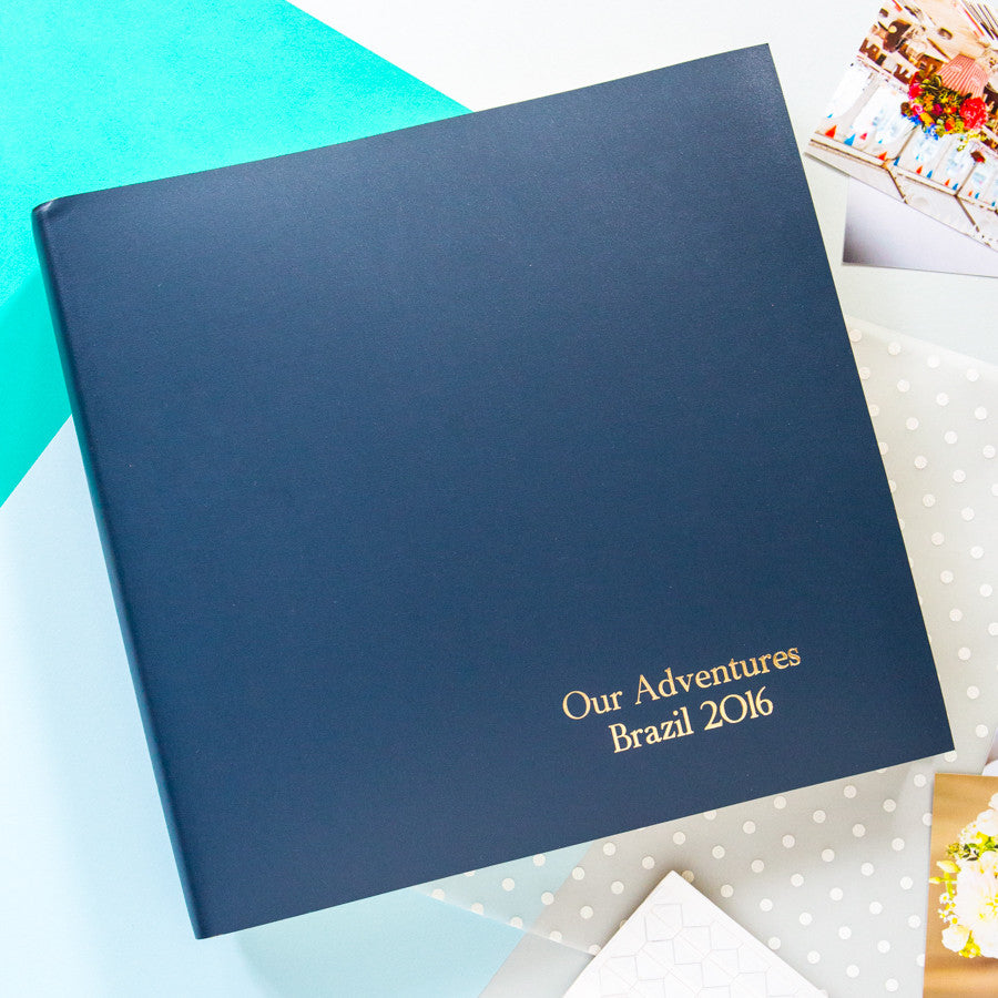 Large leather photo album with gold hot foil printing in the bottom right hand corner.